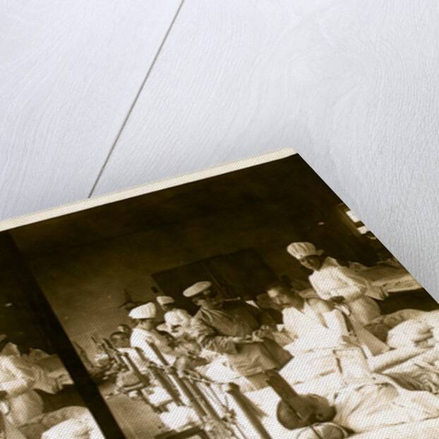 Nurses and a doctor attending wounded soldiers on a hospital ward by Anonymous