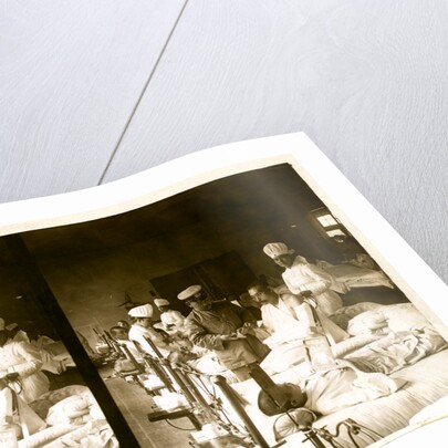 Nurses and a doctor attending wounded soldiers on a hospital ward by Anonymous
