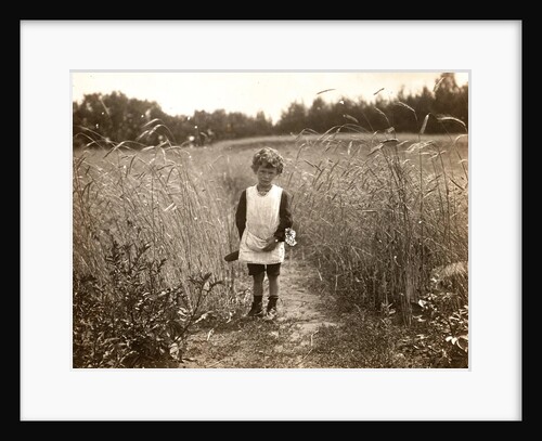 Eckart Titzenthaler, son of the photographer, standing in a field by Waldemar Titzenthaler