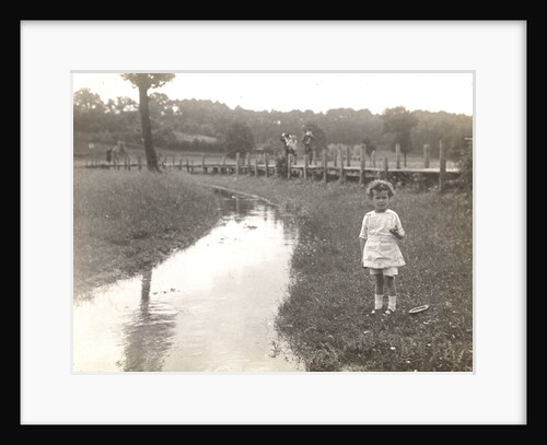 Eckart Titzenthaler, son of the photographer, standing beside a stream by Waldemar Titzenthaler