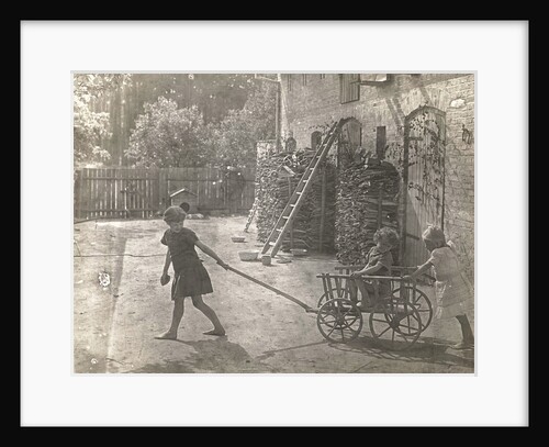 Marba and Eckart Titzenthaler, children of the photographer, girl in the yard playing with a cart by Waldemar Titzenthaler
