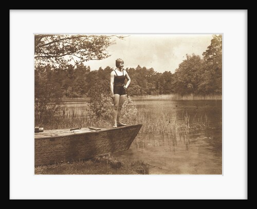 Unidentified young woman in swimsuit on a rowing boat standing on the edge of a lake by Waldemar Titzenthaler