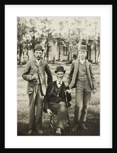 Portrait of three men standing and sitting on the grass by Anonymous