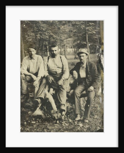 Portrait of three men sitting on a tree stump? In a forest by Anonymous