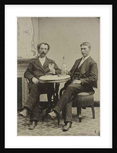 Portrait of two men sitting at the table in a studio, with a bottle and a glass, an imitation salon decor by Anonymous
