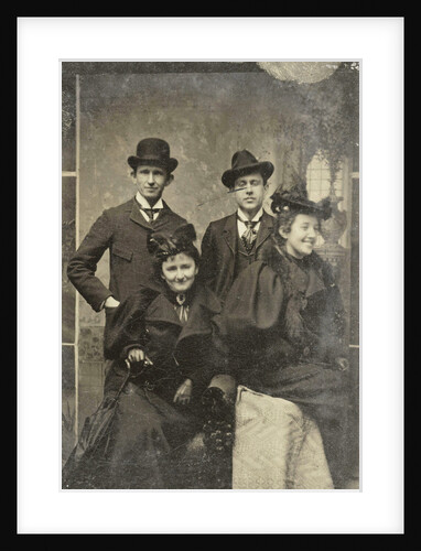 Portrait of two men and two women, one of whom looks away laughing, standing and sitting in front of a painted backdrop by Anonymous