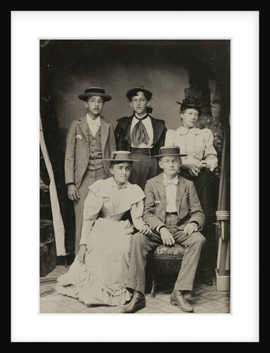 Group portrait of two men and three women, standing and sitting in a cramped studio by Anonymous