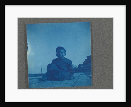 Boy sitting on wooden planks, USA by Anonymous