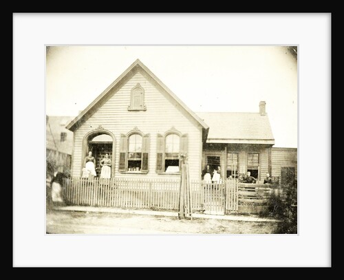 View of a wooden house with about nine people before or standing in doorways, United States by Anonymous