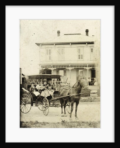 Three women and a girl (?) In a carriage with horse, with a backdrop of a wooden house by Anonymous