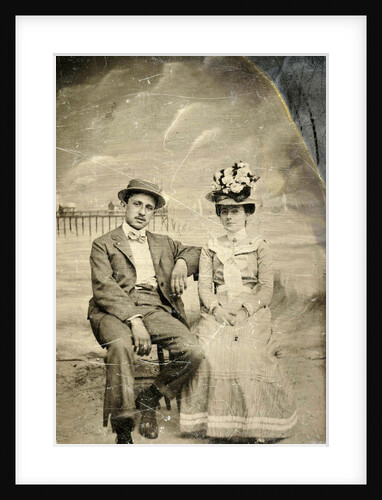 Portrait of a man and woman sitting in front of a painted backdrop (beach, sea and pier) by Anonymous
