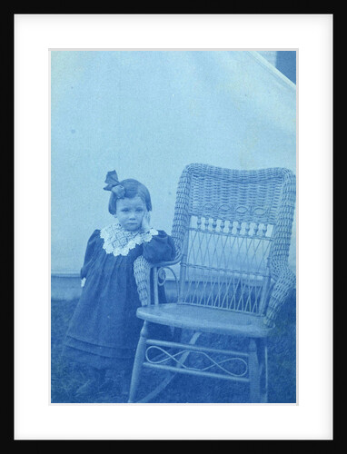 Portrait of a young girl standing next to a chair by Anonymous