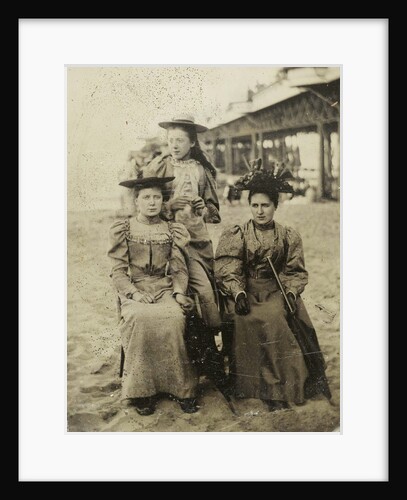 Three women on the beach, with a pier as background by Anonymous