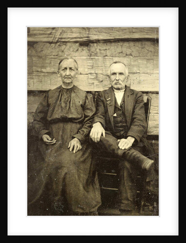 Portrait of an elderly man and woman sitting on a wooden wall or fence by Anonymous