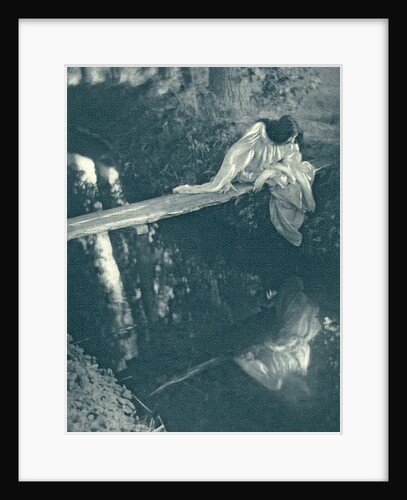 Woman sitting on a log above the water by C. Puyo
