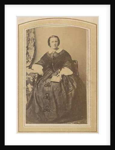 Portrait of a seated woman in a dress with a book in hand by London and Continental Photographic Copying Company