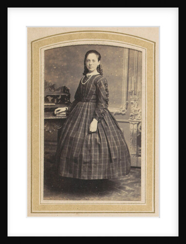 Portrait of a girl in a checkered dress at a table with books by A. Boeseken