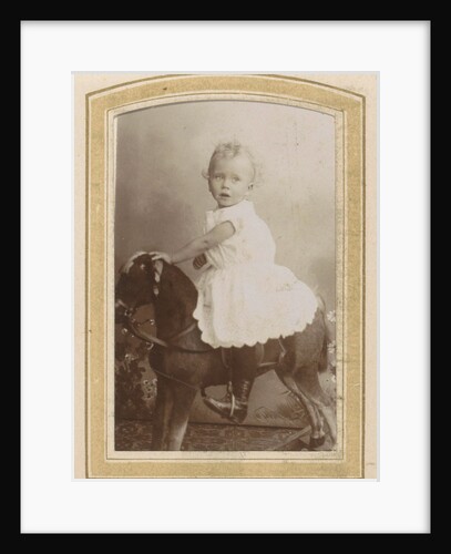 Portrait of a toddler in a dress on a rocking horse by C.J.L. Vermeulen