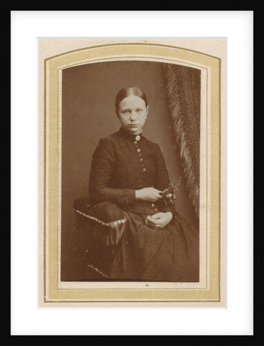 Portrait of a seated woman in a long dress with a twig in hand by H. Bulens Jr