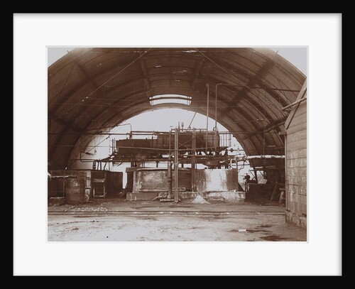 Interior of a half-round factory with a machine and pipe lines by Anonymous