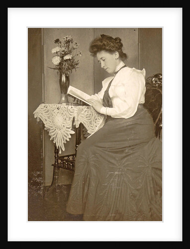Book Reading woman sitting at a table with a vase of flowers by Anonymous