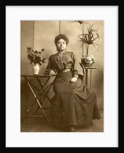 Woman sitting at tables with plants and flowers by Anonymous