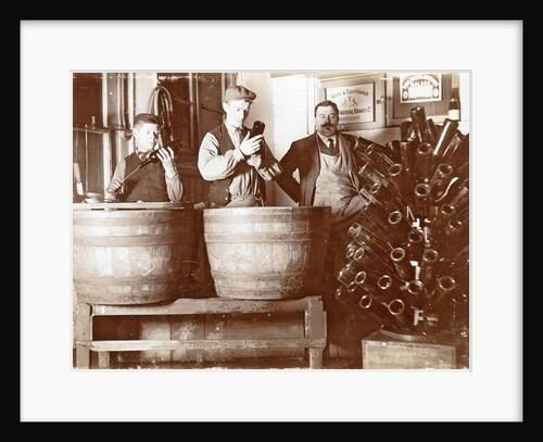 Brouwer and attendants cleaning bottles at a bottle drying rack by Anonymous