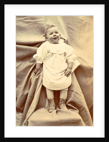 Portrait of a young child in a shirt with lace-up boots by Anonymous