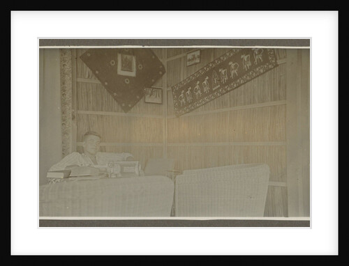 Man sitting at a table by Anonymous