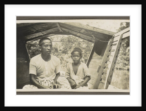 Two Indian boys sitting in roofed wooden boat by Anonymous
