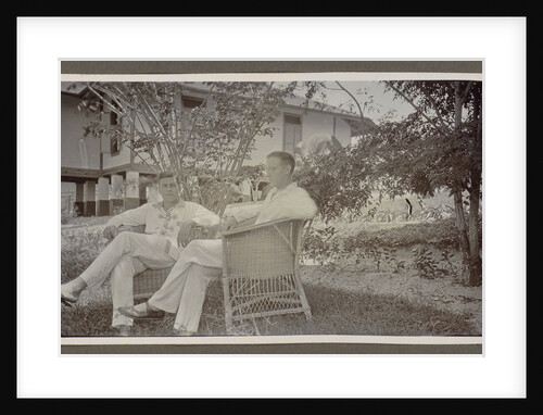 Two men in white clothes sitting in wicker chairs in a garden by Anonymous