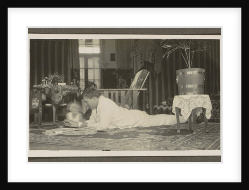 Man and a child lying on a carpet by Anonymous