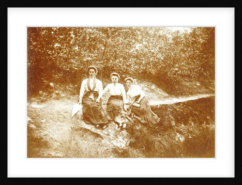 Three women sitting in a forest near a path by Anonymous