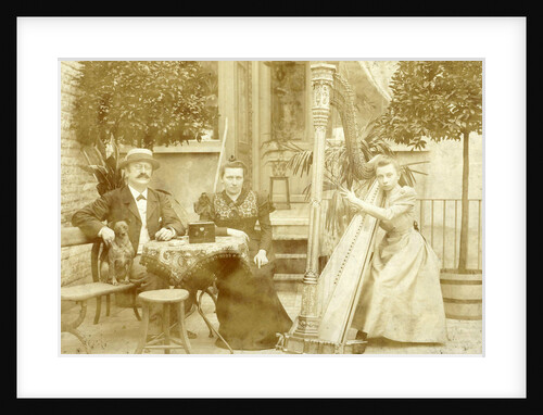 portrait of a dog sitting man seated woman and harp playing girl on a terrace by E. Dietrich