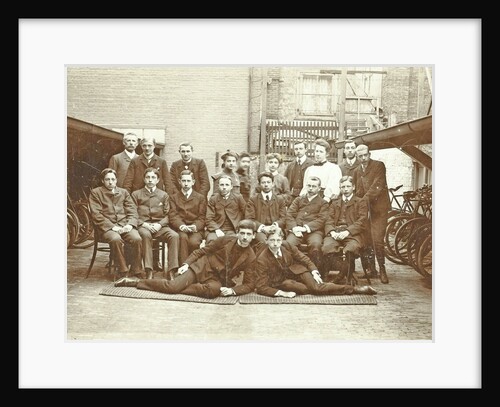 Group portrait of young men and women between two bike sheds by Anonymous