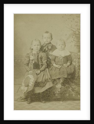 Group portrait of three children in studio by A.M. Burgess