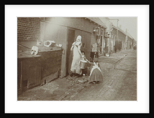 Mother and children in costume on the streets of Spakenburg by Anonymous