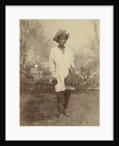 Studio Portrait of woman with paddy in her hand by Anonymous