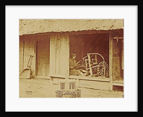 Woman at a loom in a barn by Anonymous