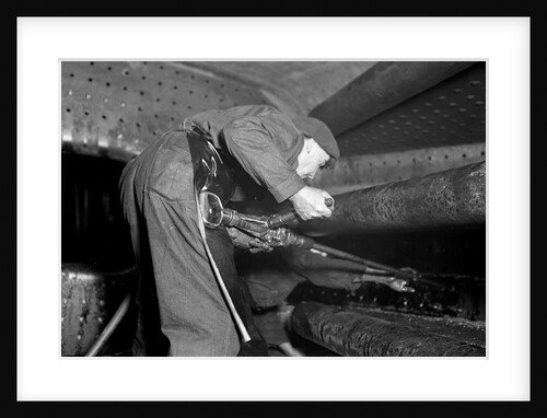 Eddystone, Pennsylvania - Railroad parts. Boilermaker tapping for stay-bolts in boiler of a modern locomotive, March 1937 by Lewis Hine