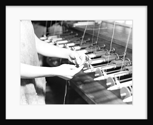 Paterson, New Jersey - Textiles. Quiller tying the broken ends of thread being wound on to quills, March 1937 by Lewis Hine