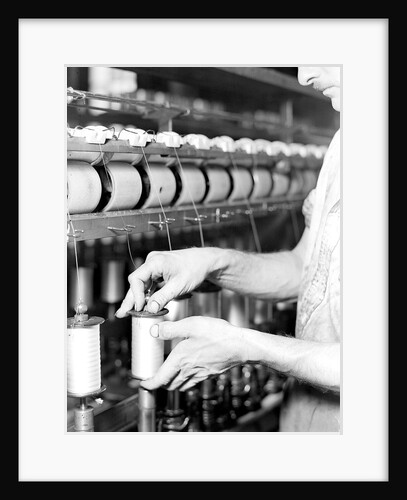 Paterson, New Jersey - Textiles. Rayon yarn being wound from one bobbin on to another and being twisted, March 1937 by Lewis Hine