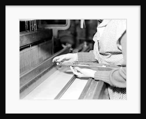 Paterson, New Jersey - Textiles. Weaver threading shuttle, March 1937 by Lewis Hine
