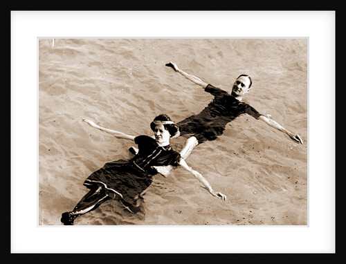 Man and woman floating on their backs in water by Anonymous