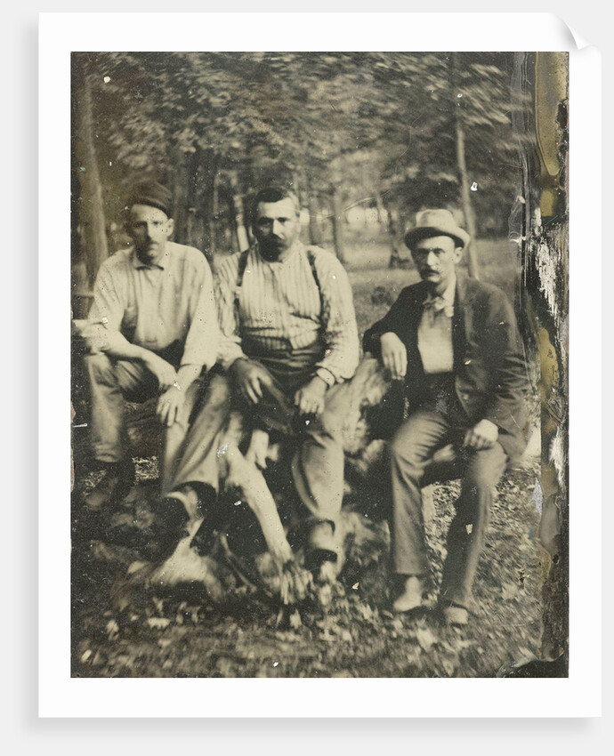 Portrait of three men sitting on a tree stump? In a forest by Anonymous