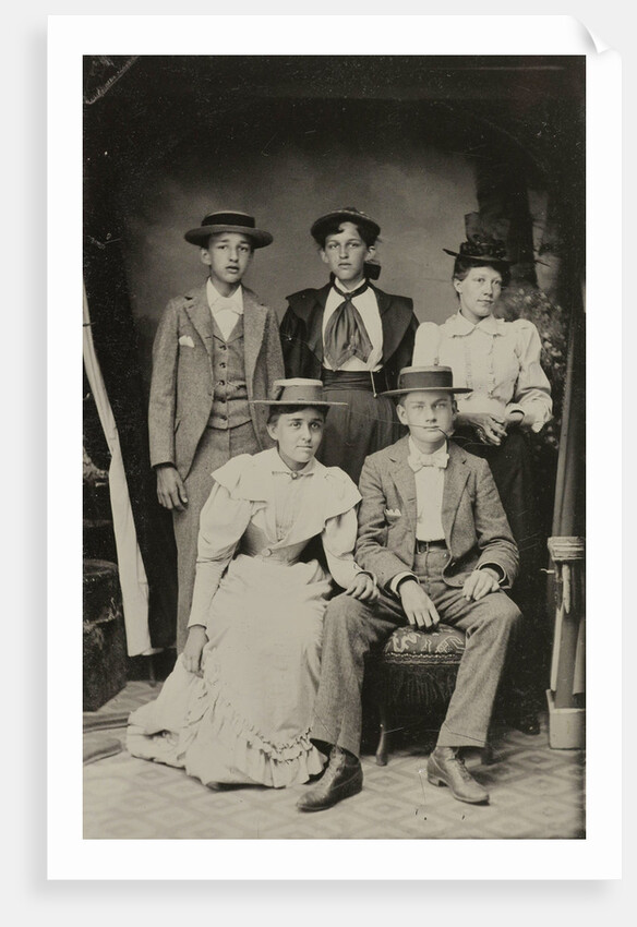 Group portrait of two men and three women, standing and sitting in a cramped studio by Anonymous