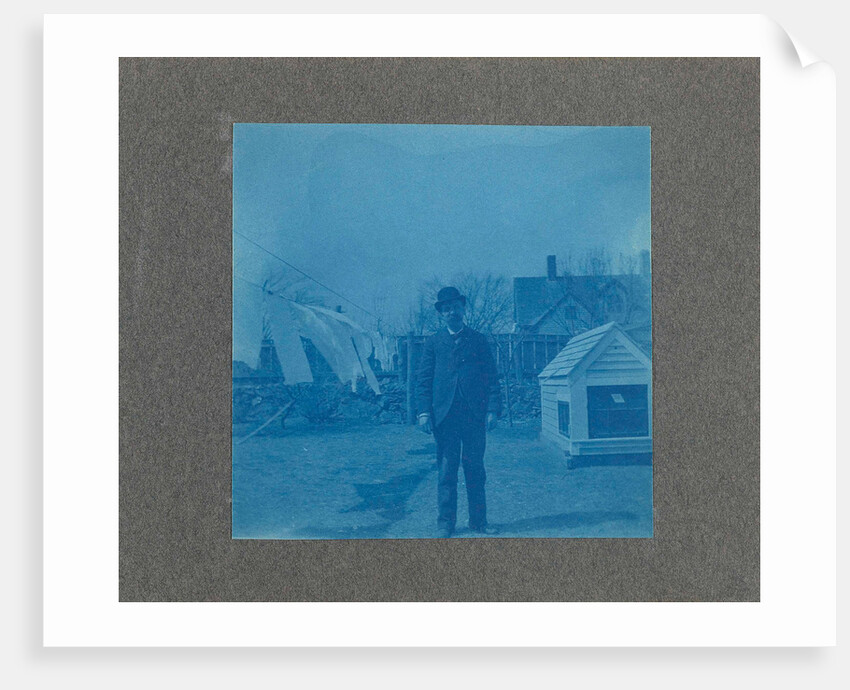 Man standing on a clothesline in a garden, USA by Anonymous