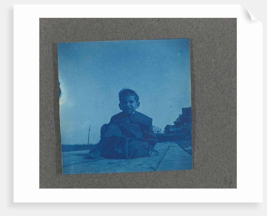 Boy sitting on wooden planks, USA by Anonymous
