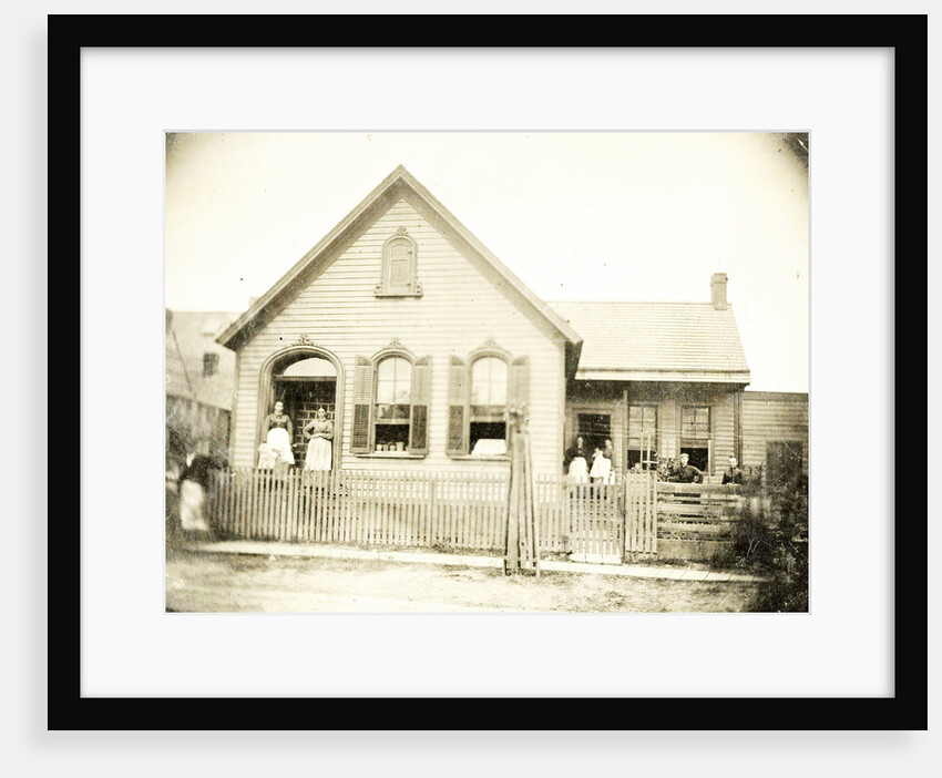 View of a wooden house with about nine people before or standing in doorways, United States by Anonymous