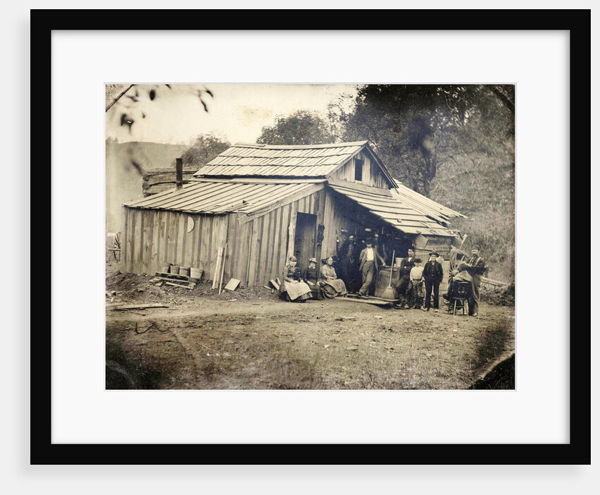 View of a wooden house with ten people, one of whom cut and / or shaved by Anonymous